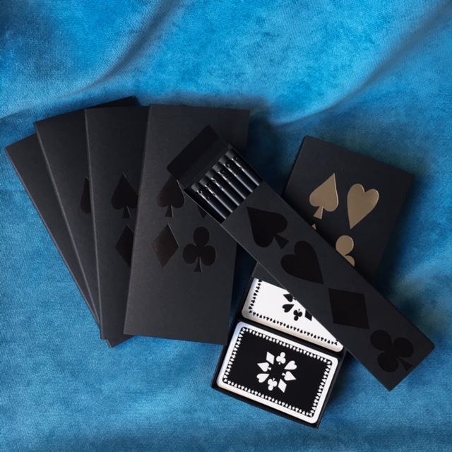 Bridge score pad in a set of four with black covers with matching box of pencils and twin box of playing cards