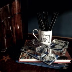 Navy and purple silver gilt playing cards with bone china mug filled with pencils for bridge scoring