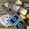 Grey sleeve box with navy and dark green playing cards