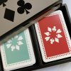 lacquered bamboo box containing twin pack of playing cards in jade and red