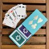 Turquoise sleeve box with violet & green playing cards