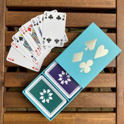 Turquoise sleeve box with violet & green playing cards