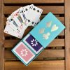 Turquoise sleeve box with violet & pale pink playing cards