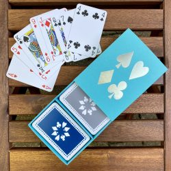 Turquoise sleeved box with blue & grey playing cards