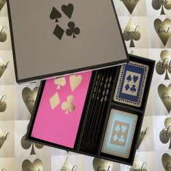 bridge game with pink scorepads and navy and duck egg playing cards plus pencils