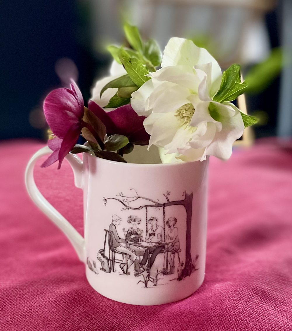 white bone china mug with people playing cards in a spring garden